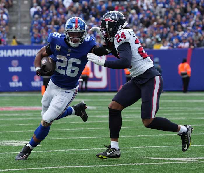 Saquon Barkley of the Giants running the ball against Derek Stingley Jr. of the Texans at MetLife Stadium in East Rutherford, NJ on November 13, 2022.